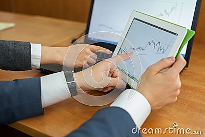 The close-up of diagram on the tablet in manâ€™s hands. Stock Photo